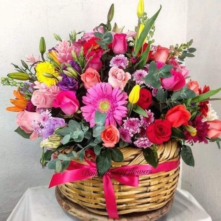 Garden-style floral arrangement in a woven basket
