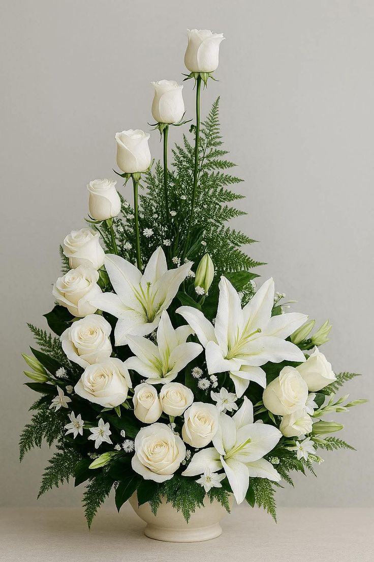 Tall white rose and lily sympathy arrangement